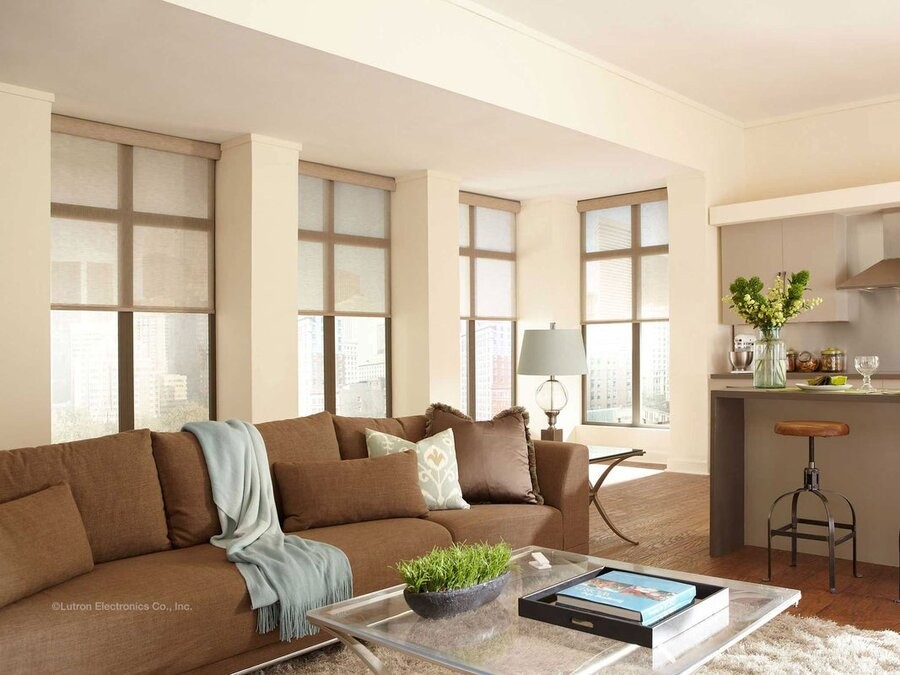A living room space featuring several windows with Lutron shades.